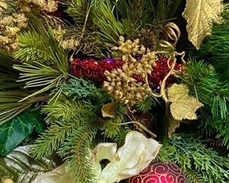 Lot 3303.  $175.00  Gorgeous Christmas Floral Arrangement, custom - made.  Top of the line florals and ornaments. This piece would work well on a mantle or down the middle of a table. 42"W x 22"H   Just beautiful!