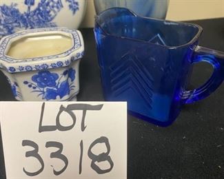 Lot 3318.  $48.00  A Blue & White Bonanza!!!  Includes 6 groupings:  13' x 8.5" x 3.5", Formalities Urn;  Perfume bottle with stopper cobalt blue, bell shape "Collegian Galss Line" Italy; Salt Shaker from Japan; Ginger Jar 8" tall; Candle 3" "Bombay"; Clear Glass & Blue Swirl vase 8" tall; Small bluie pitcher 4" x 5.75"		