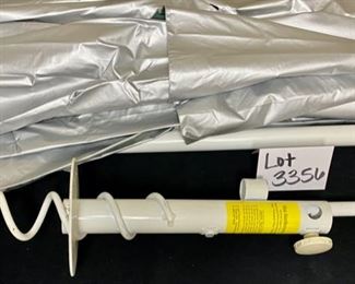 Lot 3356. $35.00.  Solar Reflecting Beach Umbrella with pole and secure Earthworm Sand Grabber Base		