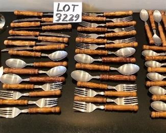 Lot 3229. 	$175.00  Great set of wood-handled flatware - stainless.  Great shape, feels "right" or ergonomically correct in your hand. Set includes: 8 each - knives, soup spoons, salad forks; 7 regular dinner forks; 2 large serving spoons, 1 each slotted serving spoon, large meat fork, ladle, sugar spoon & master butter knife.	