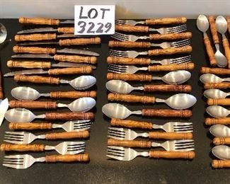 Lot 3229. 	$175.00  Great set of wood-handled flatware - stainless.  Great shape, feels "right" or ergonomically correct in your hand. Set includes: 8 each - knives, soup spoons, salad forks; 7 regular dinner forks; 2 large serving spoons, 1 each slotted serving spoon, large meat fork, ladle, sugar spoon & master butter knife.	