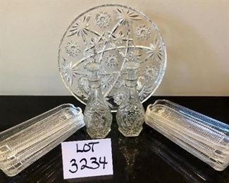 Lot 3234. $36.00  Pressed Glass Platter (11" diameter), Vinegar and Oil cruets with stoppers (7" H) and 6 corn dishes from Brazil (8.5" L).