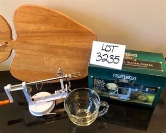Lot 3235.  $30.00 Just in time for apple season!!! Apple cutting board and Apple peeler/slicer and Glass mug 		