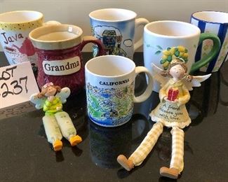 Lot 3237. $12.00  5 cute, large mugs, 1 smaller mug and 2 Don Mechanic angels.		