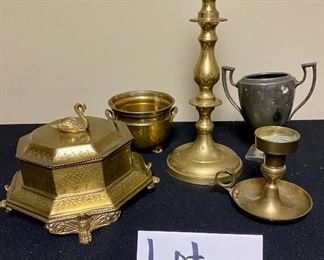 Lot 3350.  $38.00.  Vintage Brass Lot. The star of the show is this brass footed trinket box with swan finial from Andrea by Sadek (7.5 x 7.5 x 5.5"h) also includes a brass candlestick (12"h),  brass chamber candle holder (4"), brass pot by Hosley, and a double-handled challis with "W" and 211 on the bottom.		