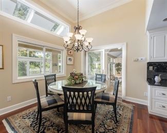 Lot 3173. $2,600.00 Fabulous Remi Lugano Limestone table with custom beveled glass top and 6 "Emerson et Cie" Dining Chairs.   (The Company's name had its origin in the French tradition of adding "et Cie" to indicate a family-owned business,  and this six-generation company moved to High Point, NC.  to take advantage of the skilled labor force for furniture building.)  The owner paid $2,350  for the table alone, an additional $1,000 for the custom cut beveled glass)  and the six chairs with custom upholstery were no doubt a fortune, as nothing from Emerson et Cie is cheap!  The table measures 58" round x 30"H; Chairs: 37"H to back, 21"W x 19"D x 20" H to seat.   You will need to have professionals move it for you.  The table is in two pieces plus the glass. 