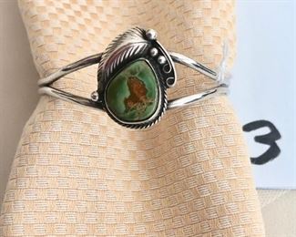 $75.00.    Signed Navajo sterling silver cuff bracelet with green turquoise.  Fits a medium to small wrist.  Expandable.