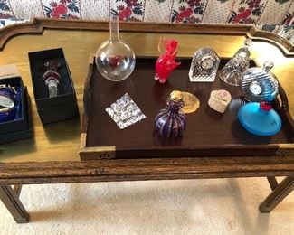 Faberge egg, "Versace" glass bottle stopper, perfume bottles, waterford clocks, bells and more - coffee table with brass top (40 x23x17) $150