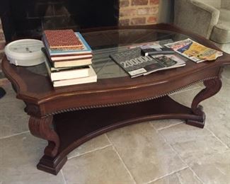 Very nice wooden coffee table with glass insert.