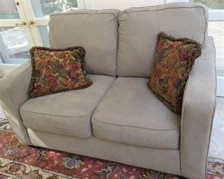 Three love seat sleepers from Ashley Furniture.