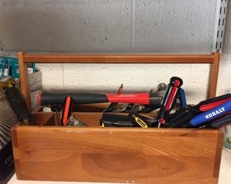 Wooden tool box filled with tools.