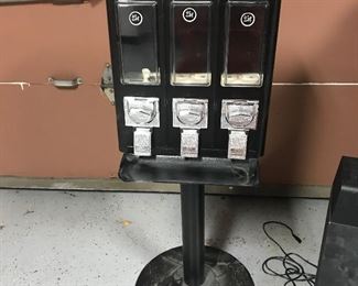 Three container candy dispenser on stand.