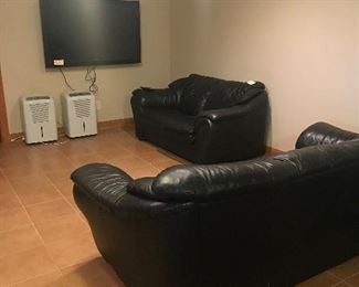 Leather black couches and large vizio tv 