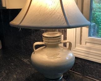 Grayish pottery lamp. Shade has some  rips $35