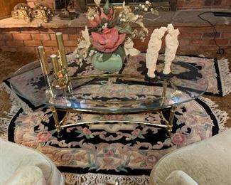 oval glass coffee table with brass base, several matching wool rugs, various shapes