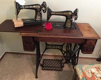 Full view of the Singer with the cabinet and showing 4 drawers. The second Singer is just the machine with attachments. 