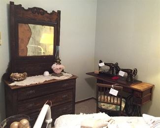 This is a really nice antique dressing table and YES! the mirror is broken but can be replaced.  Antique sewing machine table with 4 drawers and 1912 Singer Sewing Machine.  We also have a second Singer dated 1922 both with accessories.