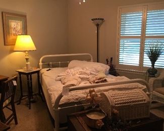 This is the guest room and it has a wonderful antique white painted full bed. The bed has a new adjustable mattress. Antique trunk, wicker trunk, wicker furniture and accent tables.
