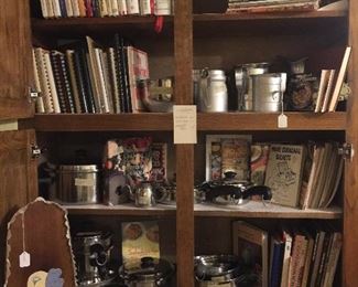 Lots of cookbooks, Salad Master Pans, vintage metal jugs and containers