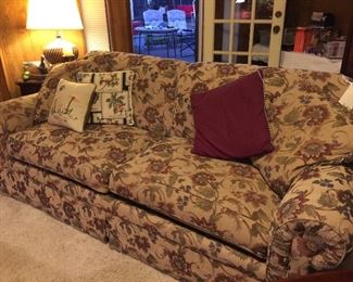 Sofa with two cushions, lots of additional cushions
