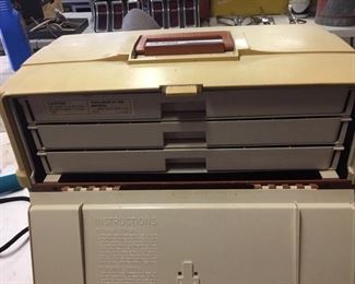 Fold the side panel down to access the three trays.