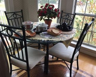 Metal and glass table with four chairs