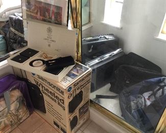 New luggage in box, new wallets, lots more brief cases and luggage