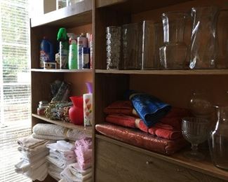 Lots of towels, vases, cleaning products, garden gloves
