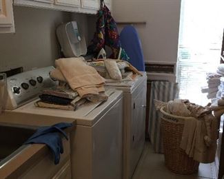 The laundry room is on the lower floor. washer, dryer and the Amana fridge, ironing boards, irons