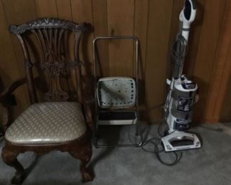 Shark vacuum with one of two arm chairs.  Small stepping stool.