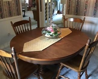 Heavy solid wood with two leafs.  One Captain’s chair, five regular chairs
