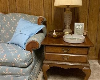 And table with glass lamp and several ashtrays