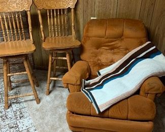 2 Pressed back oak barstools, rust colored recliner, wool blanket