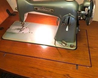 Dressmaker sewing machine with cabinet