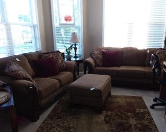 Den furniture, pictures, lamps, corner tables, plants.