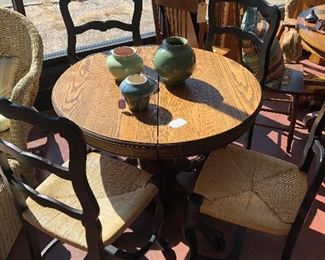 Round Oak Table, $325; Black Ladder Back Chairs, $125 each