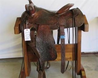 206	

Ranch Western Saddle
Ranch Western Saddle15 1/2" complete with latigo, both front and back cinches, string ties. Saddle is in good using condition.