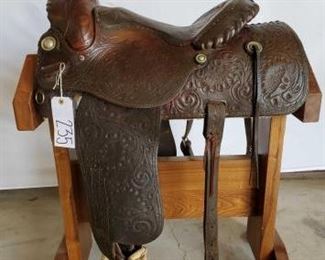 235
Western Show Saddle
15" Western Show Saddle with silver lacing on cantle and swells. Vintage silver conchos. Missing one stirrup blevins clip. Has a Danny cantle name plate on it.