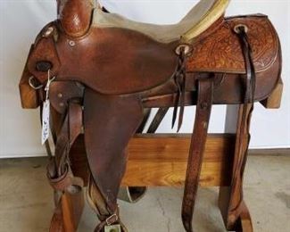 236
KM Saddlery Rope Saddle with Silver Conchos
15 1/2" KM Saddlery Rope Saddle of Chowchilla.Ca. Serial # 103. Sterling silver conchos. All rigging is complete. Breast collar is a Billy Cook. Has rawhide cantle and swell. Has 5" stainless steel bell bottom stirrups. In very good working condition. Has makers mark on saddle