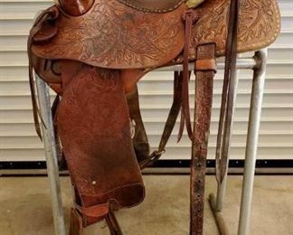 251	

Fallis Saddlery Monte Foreman Balanced Ride Buck Stitched Saddle w/ Matching Breast Collar
15 1/2" Fallis Saddlery Monte Foreman Balanced Ride Saddle in good shape with full rigging. Serial # 587-3965.Large sterling silver horn cap.  The Balance Ride Design came about in 1954 The design was started in the John Fallis saddle shop (with Monte Foreman) but several saddle makers and saddle companies produced them under the Monte Foreman Balance Ride Design for several years, including Colorado Saddlery.
Here is the web site to learn more.
Has makers mark 
www.fallisbalancedsaddles.com
