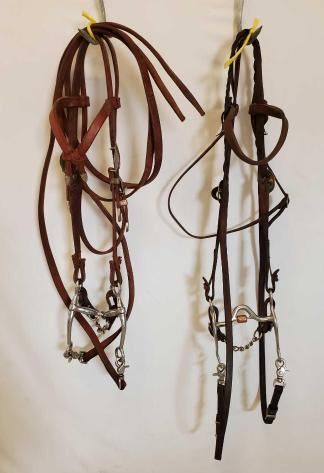 524
2 Complete used Bridles
2 Complete Used Bridals:
1- Browband Headstall With Silverado Buckles And Tips Silver Overlay With Brass/Gold accents, with Tom Thumb Bit.
1-Browband Headstall with Partrade Correction Bit with Copper Roller Mouthpiece