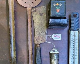 Mixed lot of kitchen items antique spoon, nutmeg grinder, match holder, thermometer, meat clever and strainer.