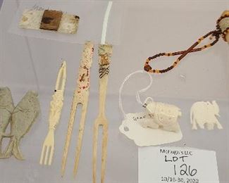Mixed lot of antique bone forks, camel , elephant and turtle pendants . Antique stone fish toggle
