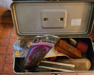 Mixed lot of small tackle box and various fishing lures and supplies.