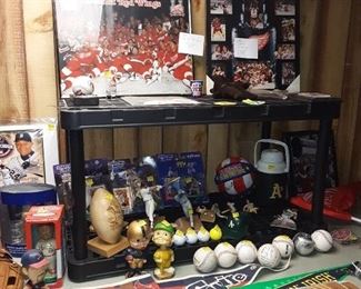 Lots of sporting collectibles, mitts, catcher gear, etc.  50% off