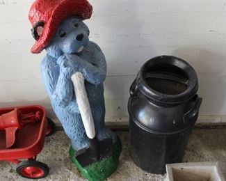 Painted milk can and a large composite blue bear
