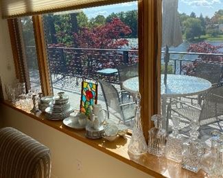 Full window sill of crystal vases & decanters.