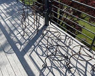 Many wrought iron plant stands.
