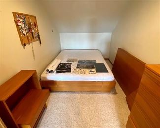 The headboard has been removed and has 2 floating nightstands.