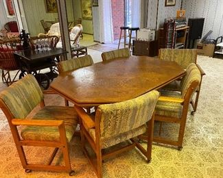 Oak conference table & six chairs on casters.